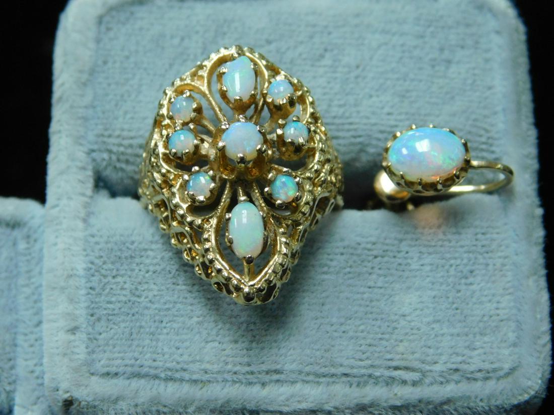 14k YG Opal Cocktail Ring & 1 Earring: 14k YG Opal Cocktail Ring and one Earring, pear shaped mounting supports nine opals - two oval and seven round. Total 5 DWT. Size 5 ring, one screw back earring. CONDITION: Very good, only one earring