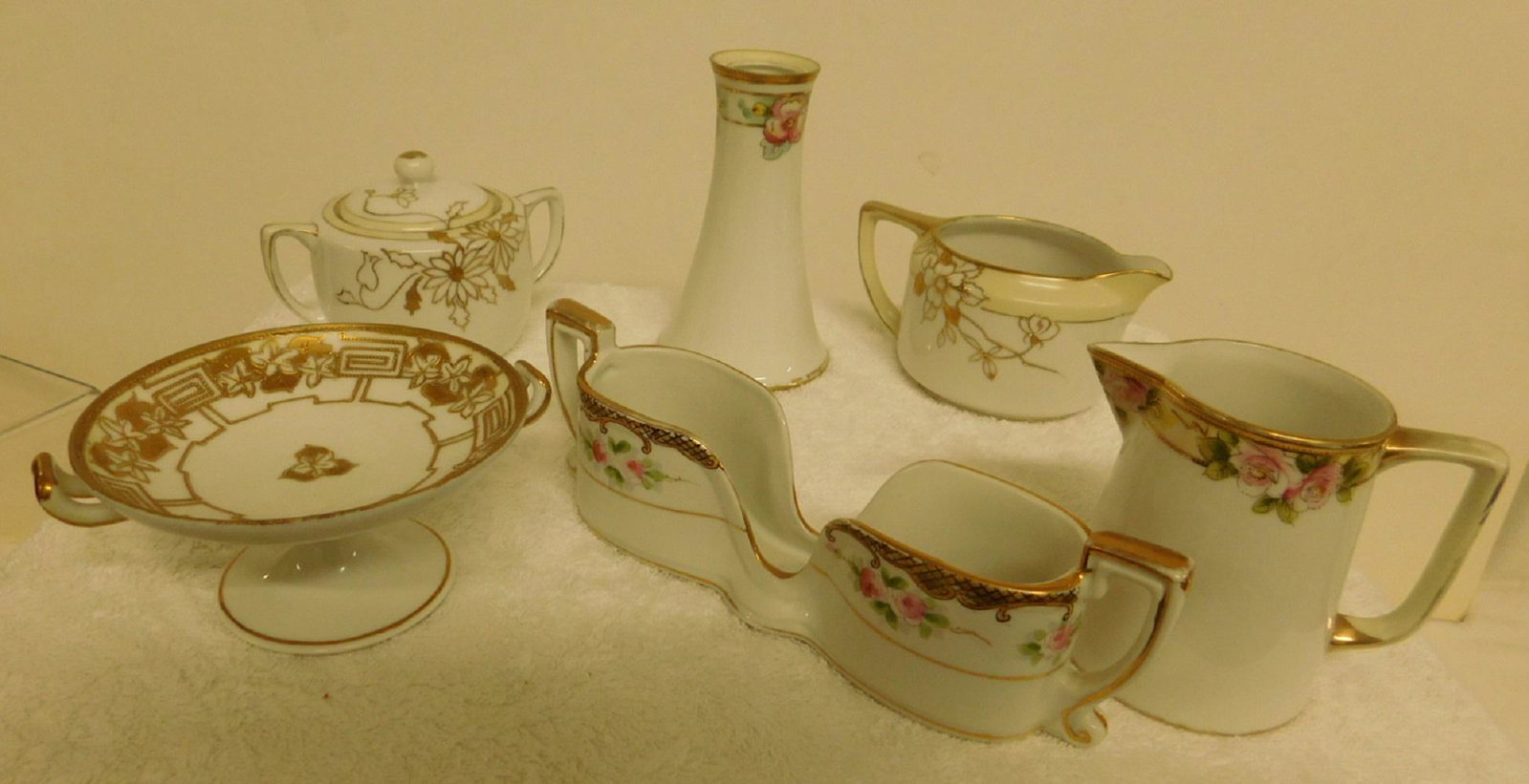 6 Pc of Hand Painted Nippon: Six Piece of Hand Painted Nippon, includes: sugar, creamers, spoon holder, hat pin holder, small compote. CONDITION: Very good.