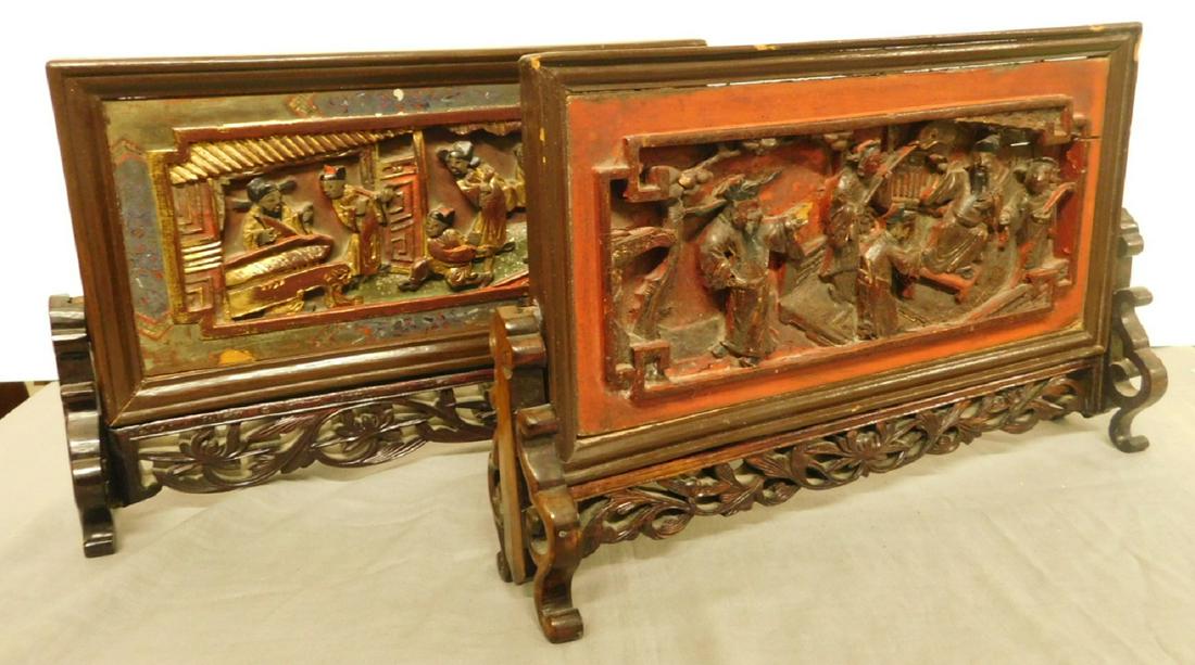 2 Chinese Candle Screens: Two Chinese Candle Screens, hardwood, relief curved panels depicting life scenes with iron red and gilt highlights, both set into pierced carved stands, 19th / 20th C, 12" x 8" x 3". CONDITION: Very g