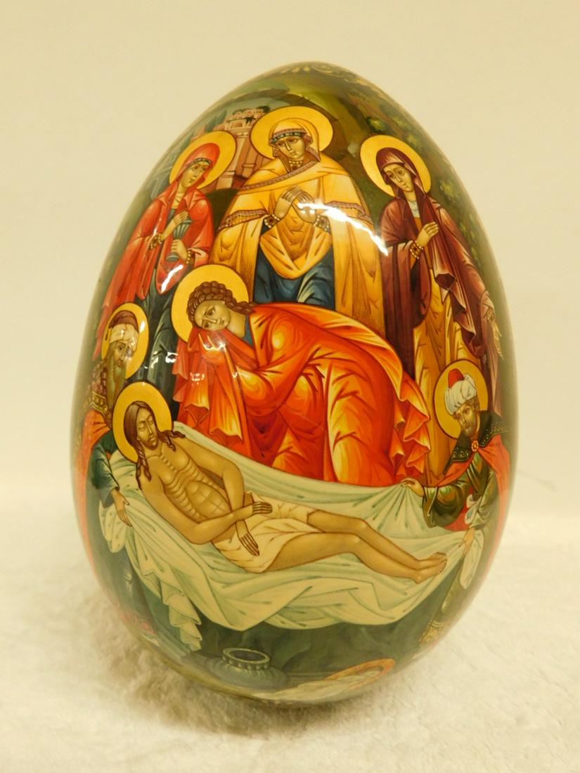 Black Lacquer Russian Egg: Black Lacquer Russian Egg, hand painted depicting Jesus Tomb, Russian Orthodox cross with leaves on reverse. Russian writing on bottom of egg, 8"h. CONDITION: A few areas of lacquer loss at top and bo