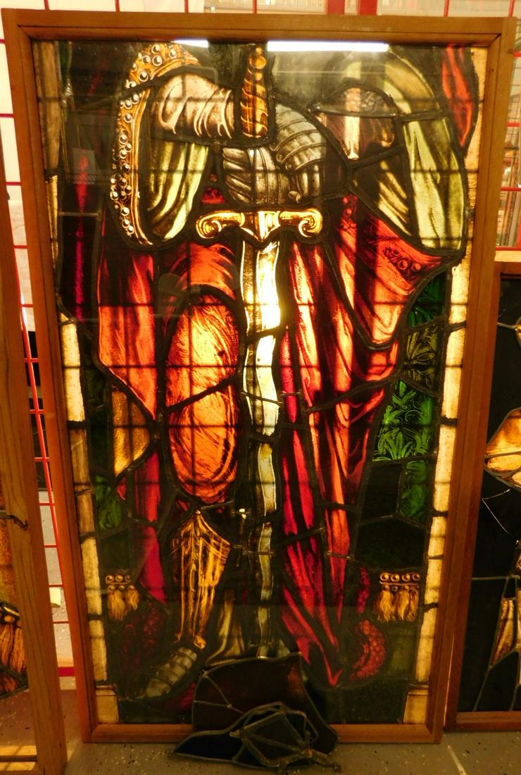 Painted & Stained Leaded Glass Panel: Painted and Stained Leaded Glass Panel, shows the standing body of a knight, mounted in a recent wood frame with protective Lucite panels on each side, 25 1/2" x 45", plus a small panel of a bearded h