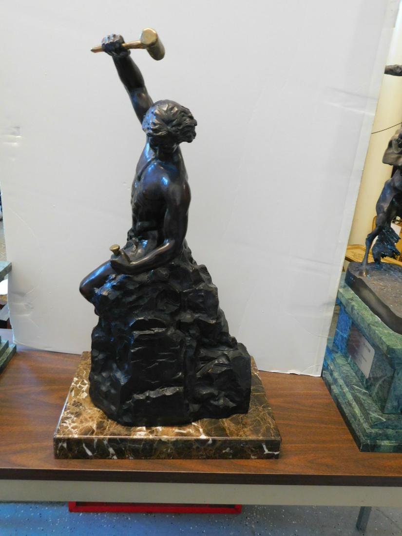 Bobbie Carlyle Bronze Sculpture: Bobbie Carlyle Bronze Sculpture, female, American artist; "Self Made Man" 1995, AP / 100, a 27 1/4" brown patinated nude male swinging a bright polished hammer into a matching chisel, signed at base; 