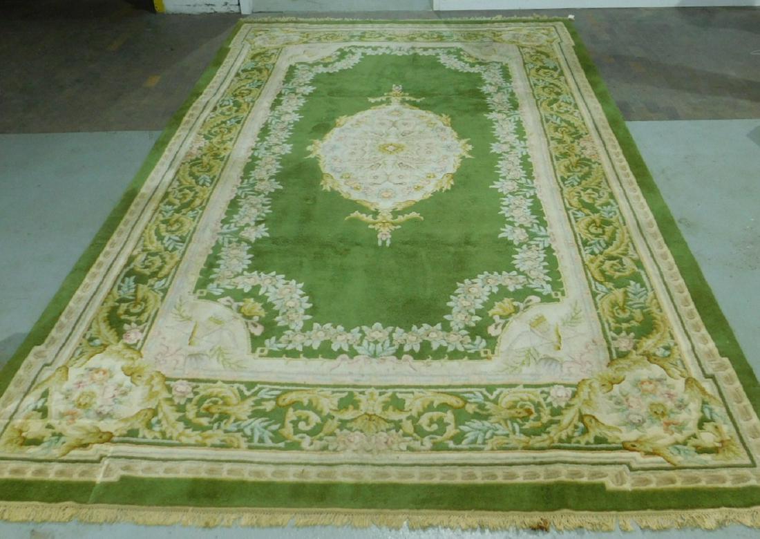 Aubusson Palace Size Rug: Aubusson Palace Size Rug, avocado green ground, creams and pastel colors central medallion and borders, mid to late 20th C., 10'3" x 16'. [22] CONDITION: Good, minor wear, small stain area on fringe, 
