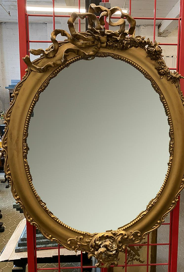 Victorian Wall Mirror: Victorian Wall Mirror, gilt over Gesso and wood, elaborate asymmetrical ribbon and rose carved crest and base, late 19th C, approx. 35" x 27". CONDITION: Small areas of old repairs and gilt loss.