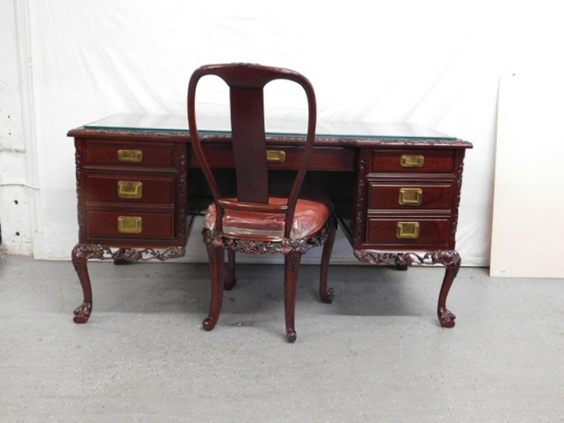 Chinese Executive Kneehole Desk and Chair: Chinese Executive Kneehole Desk and Chair, Rosewood, flat top with inset protective glass and relief carved berry and vine border, one long drawer flanked on each end by two short drawers, all with br