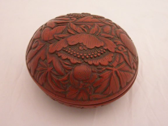 Japanese Cinnabar Lacquered Round Box: Japanese cinnabar lacquered round box with overall floral & leaf relief carved motif. 19th c., diameter 3 1/4", hgt 1 3/4"
