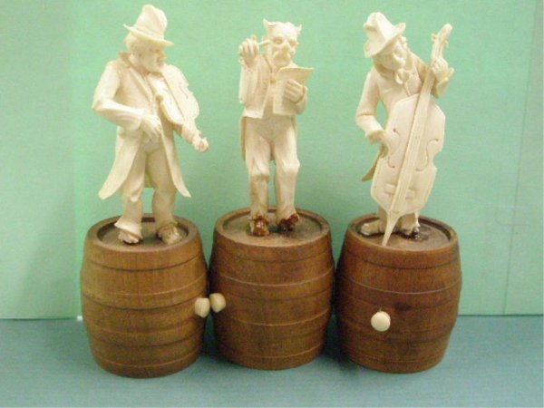 Three Continental Ivory Musicians On Wood Barrels: Three Continental ivory musicians on wood barrels; conductor, bass player, violin player, hgt 5 1/2", early 20th c., [23] No International Shipping