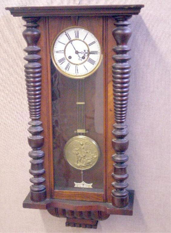 Wall Regulator Clock: Wall Regulator clock, walnut, porcelain dial, figural embossed brass pendulum, time & strike movement, late 19th c., 15 3/4" x 32 3/4" x 6 1/4"