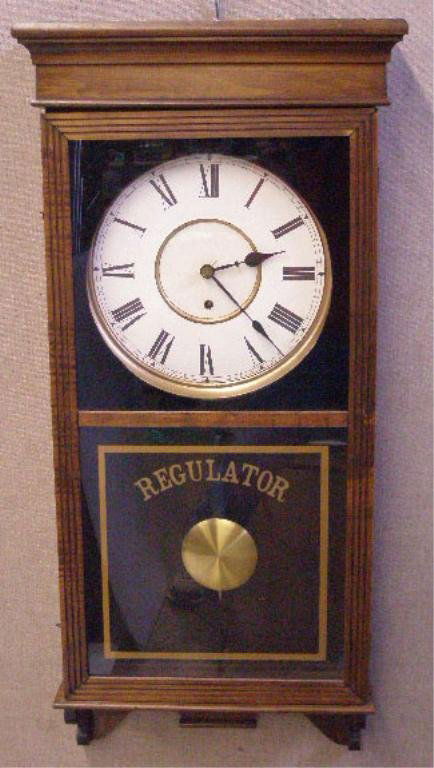 Wall Regulator Clock: Wall Regulator clock, walnut finish, paper dial, time only movement, early 20th c., 38" x 17" x 5"
