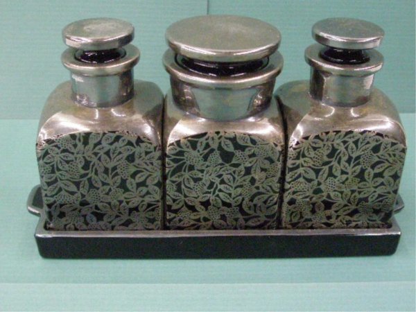 1930's Silver Overlay Glass Toiletry Set: 1930's black glass w/silver overlay game birds & floral design four piece toiletry set, pair 4 1/2" toilet water bottles, 4 1/2" cotton ball jar & 9" tray