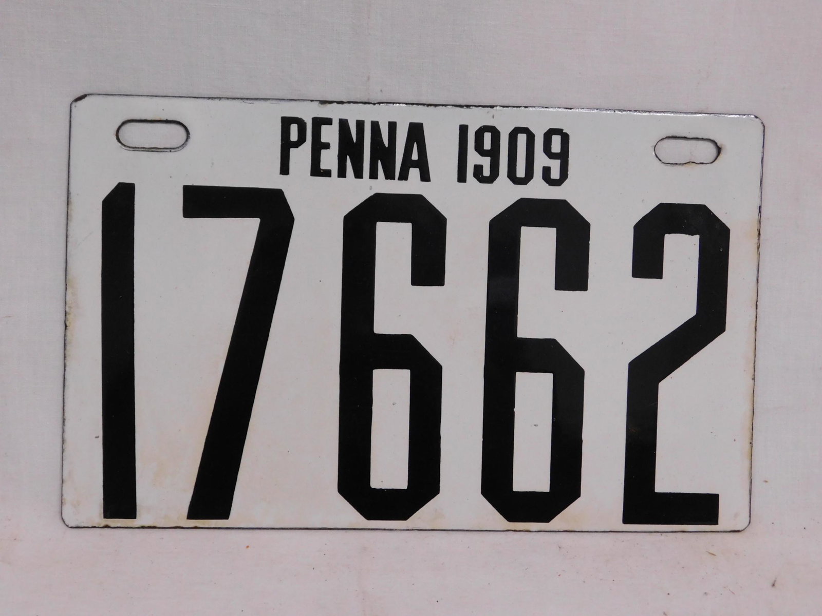 1909 Pa. Porcelain License Plate: 1909 Pa. Porcelain License Plate, white with black letters and numbers, 17662, 6 1/2" x 10 1/2", Ingram - Richardson Mfg. Co.(Ing - Rich) Beaver Falls, Pa. CONDITION: Minor enamel loss along edges and