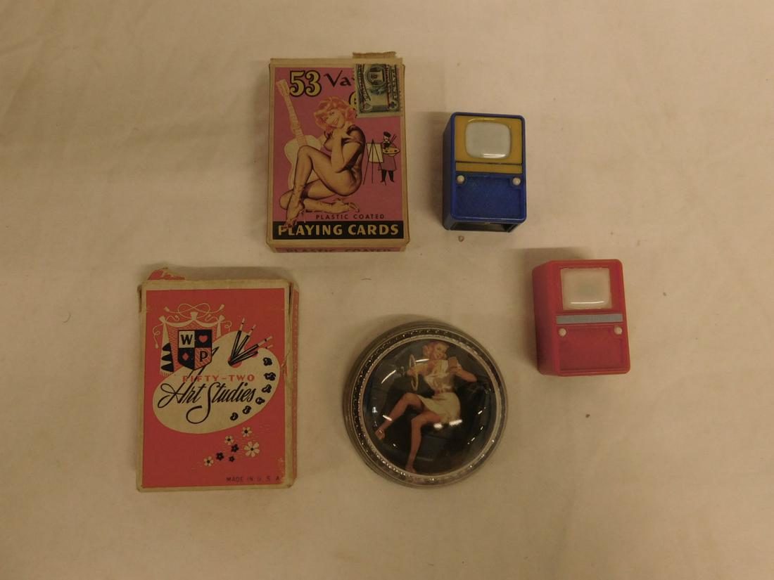 Erotica Group: Erotica Group, includes: glass paperweight, two decks of illustrated playing cards and two plastic television shaped viewers. CONDITION: Wear to card cases, viewers push button bottoms are stuck.