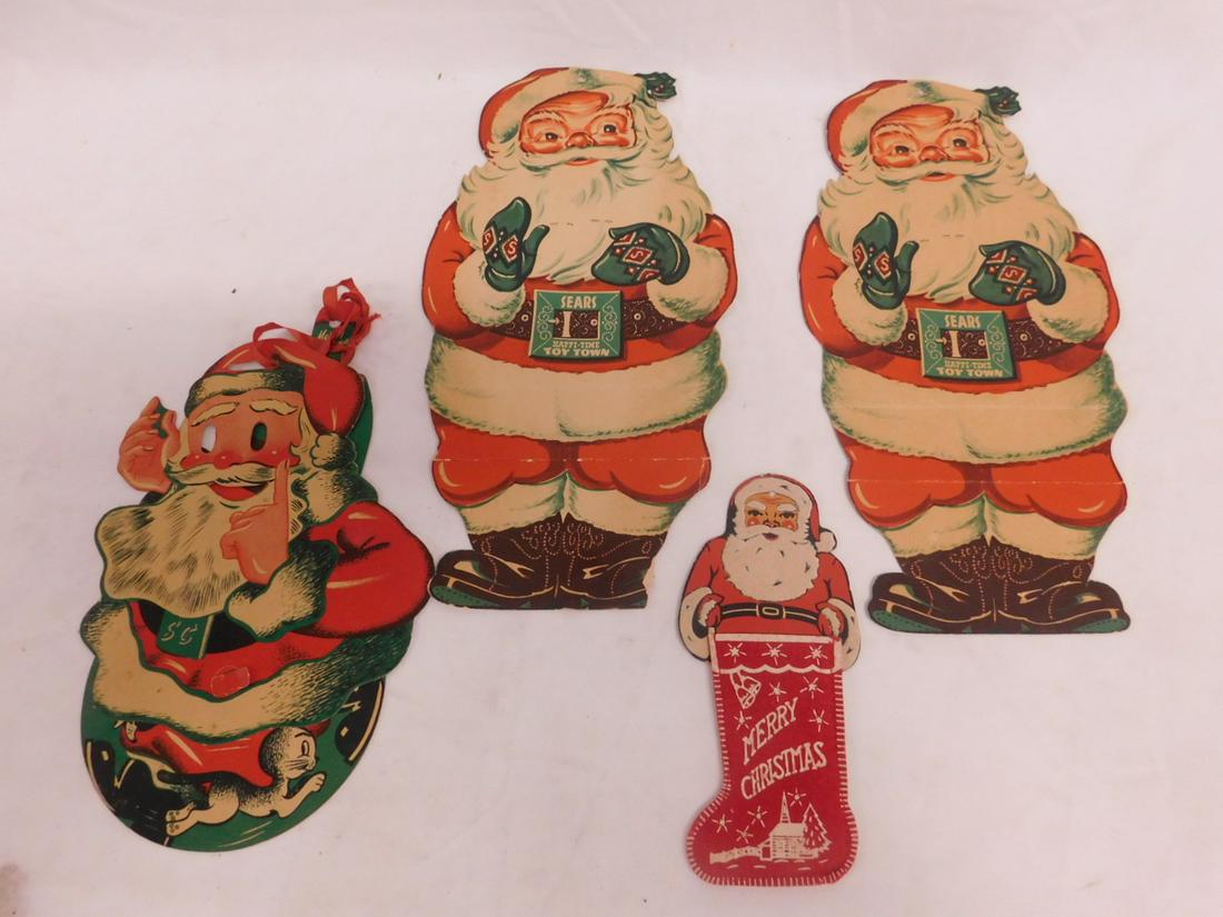 4 Vintage Santa Action Cut Outs: Four Vintage Santa Action Cut Outs, two "Sears Happy - Time Toy Town' with winking eyes (height 13 1/2"); S(ears) C(company) Santa on wheel base with moving arms, feet and eyes; verso with "Funny Face