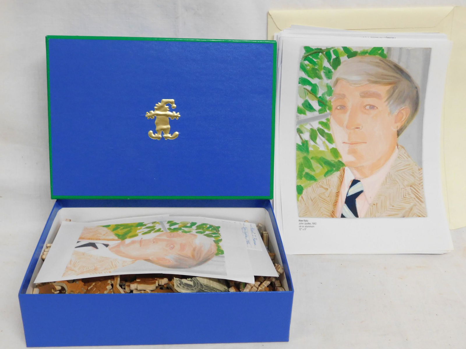 [Updike] Stave Hand-Cut Jigsaw Puzzle: A custom hand-cut wooden jigsaw puzzle commissioned by Albert J Raman from Stave Puzzles of Norwich, Vermont. The image is a painting of author John Updike by Pop artist Alex Katz, which was commissio