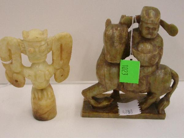 Chinese Serpentine Carvings: Two Chinese serpentine carvings, green/brown figure on horseback, 5 1/4" x 6" & a cream colored winged figure totem, 5 1/2", 20th C.