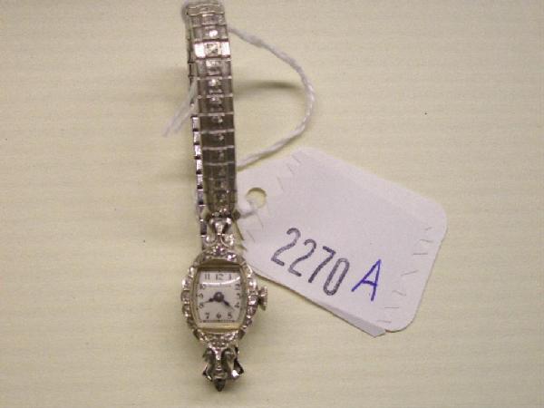 14k Lady's Bulova Watch Case: 14k white gold diamond lady's Bulova watch case w/gold filled Speidel band, 8 accent diamonds. 2" inside across