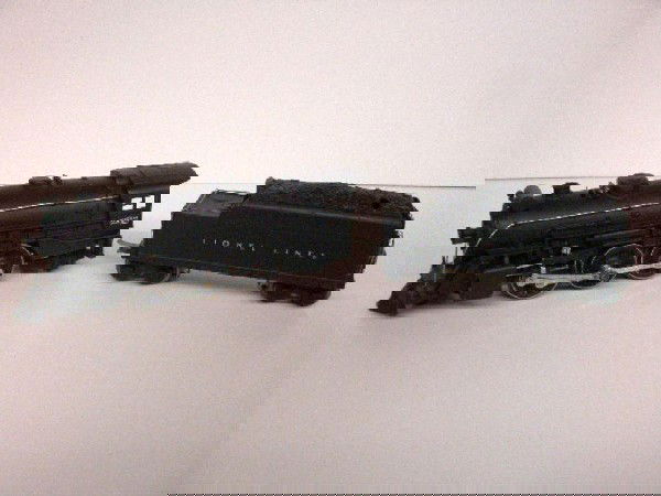 Pre War Lionel Locomotive & Tender: Pre war Lionel #225E Steam 2-6-2 Locomotive & #2235W Tender. CONDITION: Locomotive has possibly been repainted, tender has been repainted & has cracks & areas of minor paint loss on both.