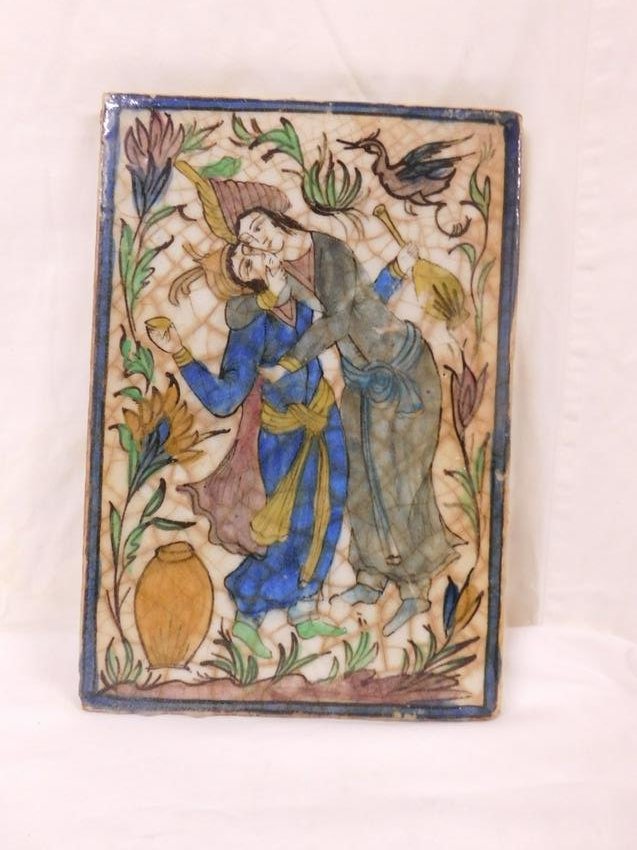 India Porcelain Tile: India Porcelain Tile, painted and glazed porcelain depicting lovers in garden with bird and wine containers, 19th / 20th C, 9 3/4" x 13 3/4". CONDITION: Very good. Very minor edge flakes.