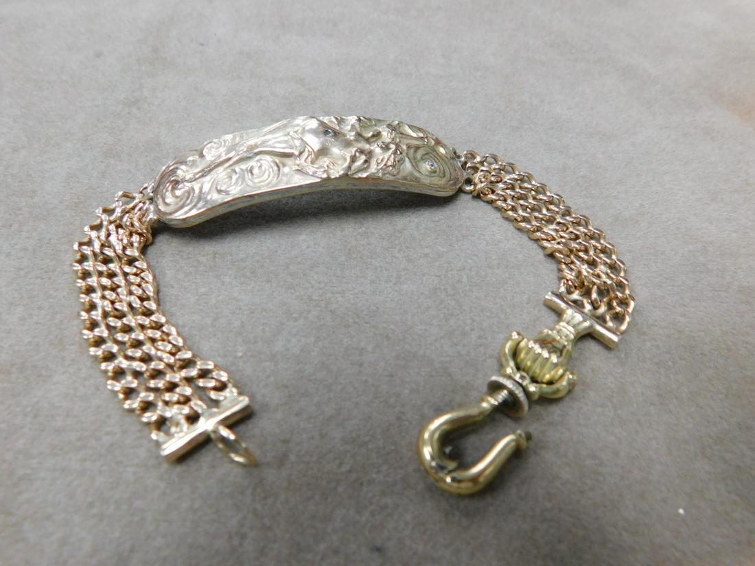 Art Nouveau Bracelet: Art Nouveau Bracelet, tested 14k yellow gold, nude female with flowing hair, star, swirls with accent diamond mounts on silver backing. Triple chain link bracelet with fist and hook closure. 8" length