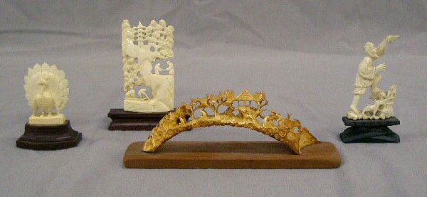 4 Chinese Carved Ivory Sculptures: 4 Chinese Carved ivory sculptures includes: 5" village scene openwork tusk, 3" village scene plaque, 2" peacock, and 2 1/2" fisherman with dog, all on wood stands. No International Shipping. [38]