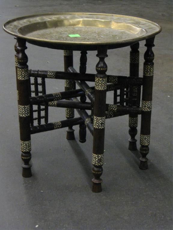 Persian Tray Table: Persian tray table, embossed brass 17 1/2" tray on six leg Moorish style base inlay hard wood base, early 20th C. 17" height.