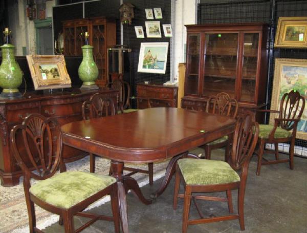 10 Piece Stylized Dining Room Set: Ten-piece stylized dining room set, mahogany. Includes: carved Chippendale style china closet, sideboard & server, six Federal style chairs, double pedestal extension table w/leaf, mid 20th C.