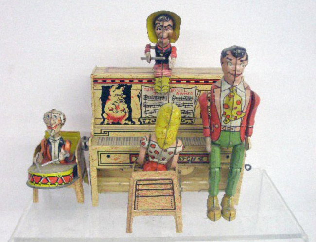 Unique Art Tin Wind-Up Lil Abner Dogpatch Band: 1945 Unique Art Manufacturing Company lithographed tin wind-up 8" Lil Abner Dogpatch Band.