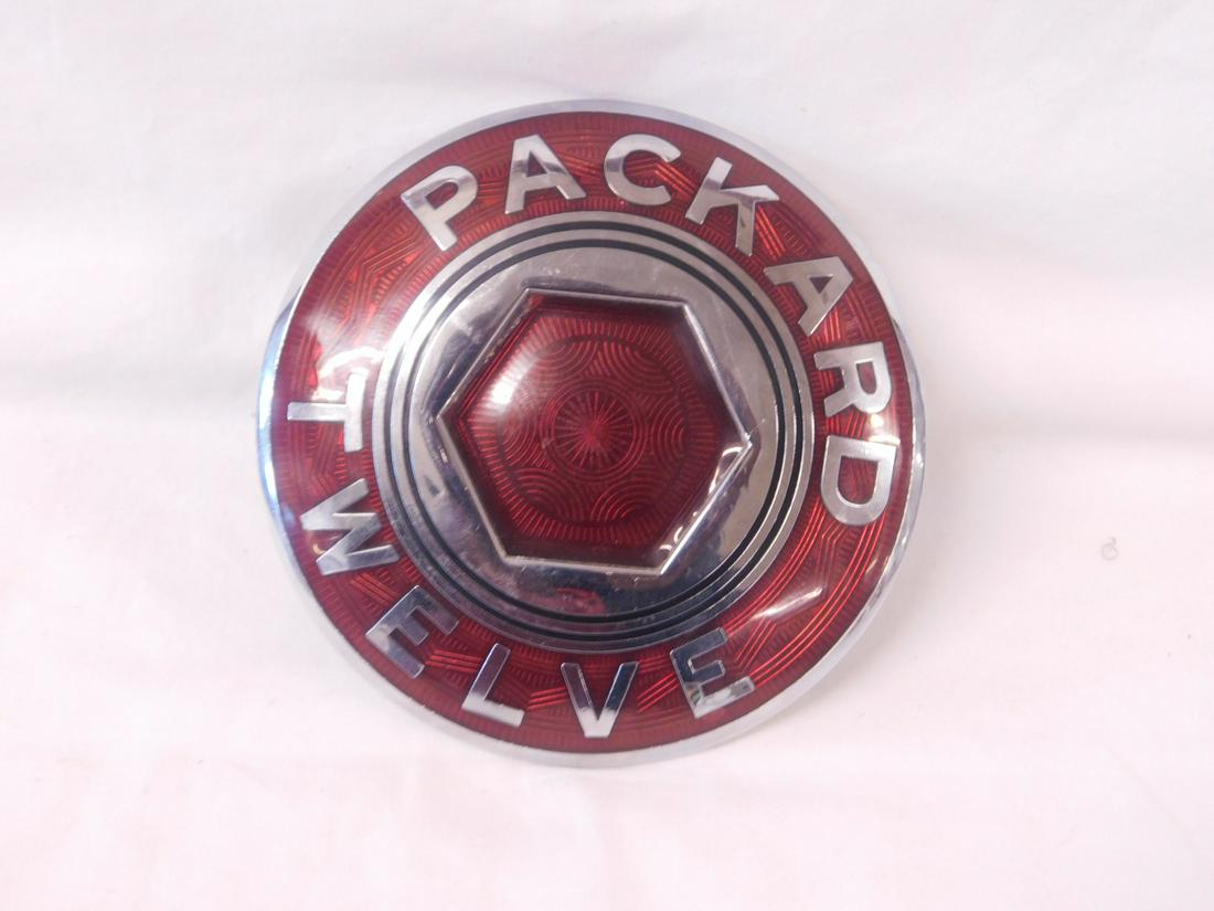 Packard Twelve: Packard Twelve, vintage single wheel hum emblem 1933 or 1934 enamel badge. CONDITION: New old stock.