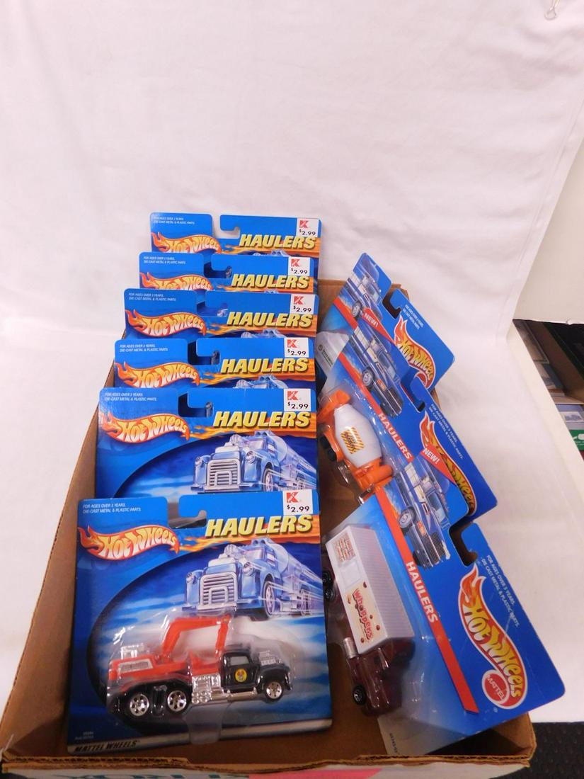 Hot Wheels Haulers Trucks NIP: Hot Wheels Haulers Trucks, new old stock including: 1997 - Waste Management, 1998 - Whoppers and New Cemend, plus 2001 (6) 89284 - 89289. CONDITION: New old stock, package may have minor wear.