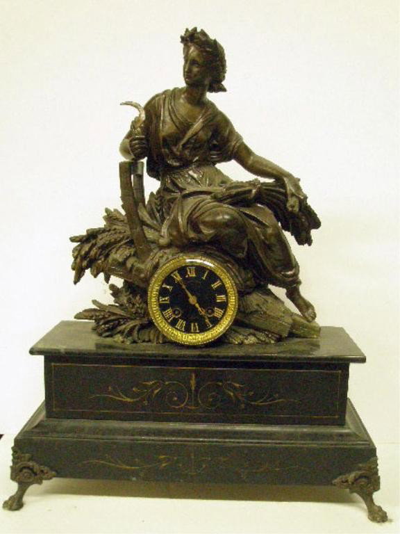 Guirauden Victorian Figural Mantel Clock: Guirauden Victorian figural mantel clock, slate, gold highlights, black porcelain dial, bronzed spelter metal goddess on cart of wheat, late 19th c., 17 1/2" x 7 1/2" 21 3/4". [10]