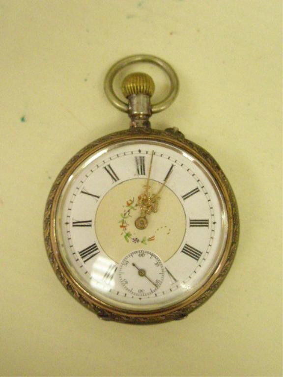 800 Silver Pocketwatch: 800 silver pocketwatch, German, two toned, hallmarked w/crescent moon & crown & spiked pickle helmet, porcelain dial w/Roman numerals & floral decoration, size 12, chaised scroll & shield design. [6]