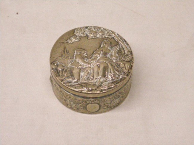 German 800 Silver Box: Late 19th/early 20th c. German 800 silver hallmarked 3" round box w/embossed courting scene on lid & embossed floral border on base, 3.47 troy ounces.