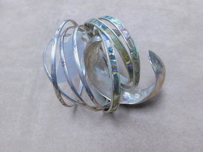 8 Sterling Silver Bangle Bracelets: Eight Sterling Silver Bangle Bracelets, includes: hand hammered 25mm wide cuff bracelet, four matching engraved 3mm wide bangles, 2 1/2" interiors, and three abalone inlaid 5 and 6mm wide, 2 1/2" to