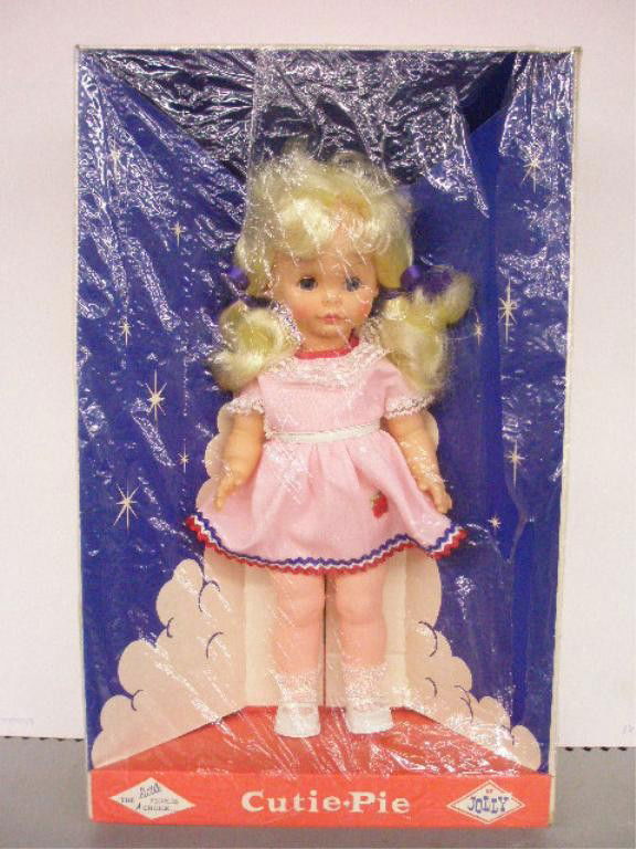 1960's Jolly Toys Cutie Pie Doll: 1960's Jolly Toys Inc. 13" vinyl & hard plastic Cutie Pie doll with sleep eyes, sealed in original box. Condition: Doll is very good, box has wear & tearing.