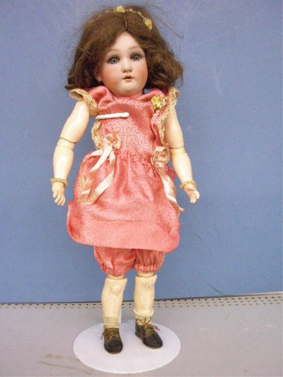 Dressel Bisque Head Jutta Child Doll: c. 1906 Cuno & Otto Dressel 16" bisque head & jointed composition body Jutta child doll, sleep eyes, open mouth. Condition: Very good with areas of wear on body, hair is detached.