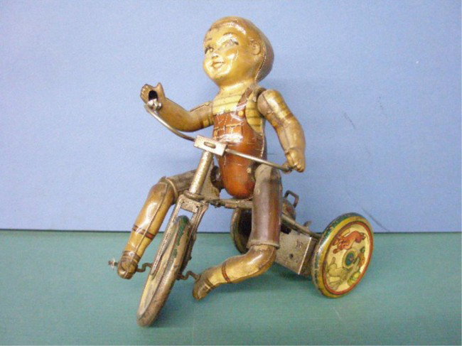 Unique Art Tin Wind-Up Kiddie Cyclist: 1940's Unique Art Manufacturing Company lithographed tin wind-up Kiddie Cyclist. Condition: Not working, over all wear & loss. not working, over all wear & loss