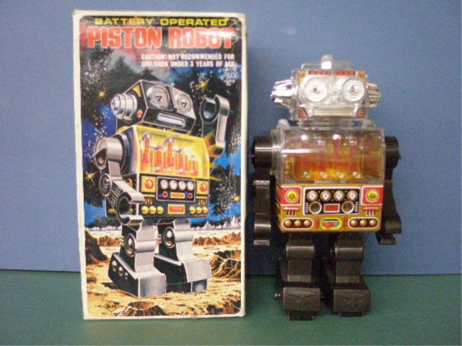 1960's Japanese Battery Operated Piston Robot: 1960's S-H Co. Japanese tin & plastic battery operated Piston Robot w/original box. Condition: Very good with minor wear, lights up but no other actions, box has wear. =
