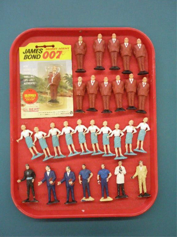 1965 A.C. Gilbert James Bond Figures: Twenty-nine 1965 A.C. Gilbert Company plastic James Bond Secret Agent 007 figures, 1 sealed on packaged card. Condition: All have some form of wear & or loss, separation on leg of scuba Bond.