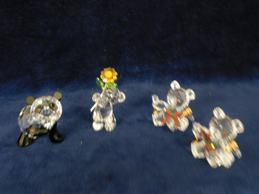 4 Swarovski Bears: Four Swarovski Bears, includes: "Mother Panda" No. 181080; "Kris Bear" with flower and certificate of authenticity; and two "Kris Bear" No. 7637 with wine bottle and goblet; all with original boxes. C
