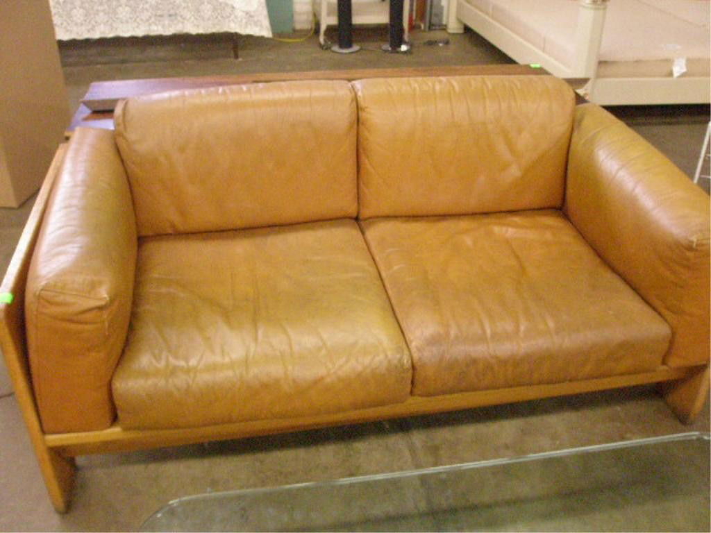 Love Seat: Love seat, unmarked, presumed by Knoll, oak, leather cushions, mid 20th c. Condition: Slight soiling to upholstery.