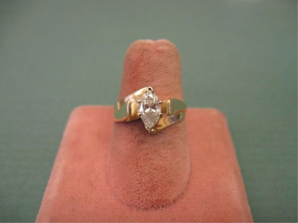 1/2+ ct Marquise Diamond Ring: 1/2+ ct marquise diamond ring, set in 14k yg contemporary mounting, size 6 1/4, 2.5 DWT. Cond. Some inclusions & possible J-K color. No appraisal. [3]