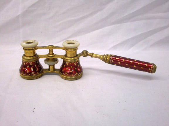 French Enamel Opera Glasses: Late 19th/early 20th c. A.B. Griswold & Co., New Orleans, French enamel, brass & Mother of Pearl opera glasses with moveable side handle. Condition: Very good with 1/4" crack & small mark under the en