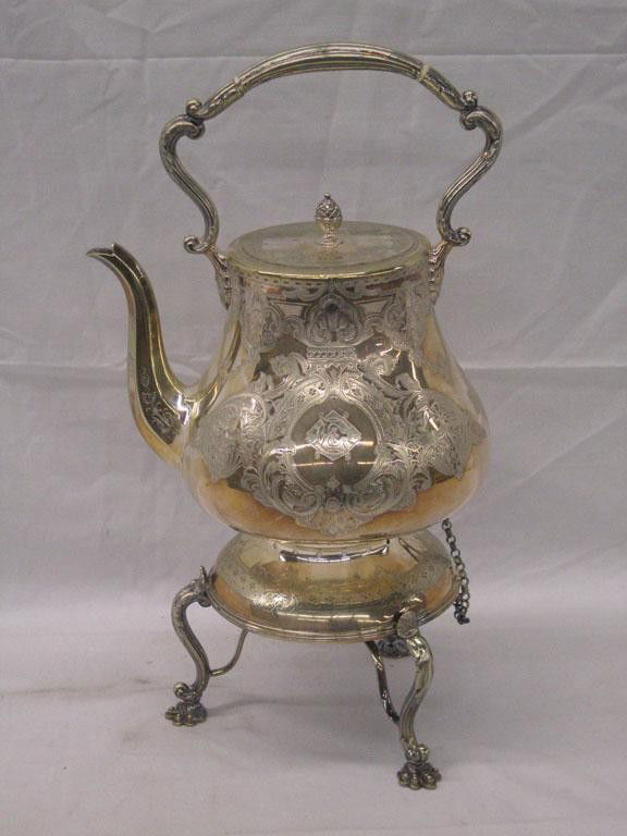 English Silverplate Hot Water Kettle: c. 1863-1894 Mappin Brothers English silverplate 17" tilting hot water kettle on stand, chaised floral design, pineapple finial on lid, scroll handle with Ivory mounts, scrolled paw feet on stand, ori