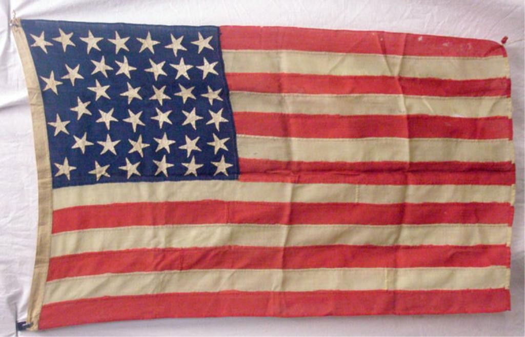 19th c. 38 Star American Flag: c. 1877-1890 thirty eight star American flag, 54" x 33". Condition: Areas with wear, holes & tearing.