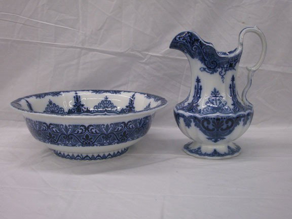 Flow Blue Pitcher & Wash Bowl Set: 20th c. French porcelain hand painted 12 piece fish set: eleven 7 1/2" serving plates & one 23 3/4" serving platter. Condition: Very good with chips on back of 1 plate.