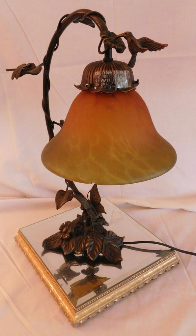 Art glass style desk lamp: Art glass style desk lamp, cast metal humming bird and butterfly frame with art glass pendant shape, 14" h , plus beveled glass top stand, 9" x 9" x 1 3/4". Condition: chips along edge of shade