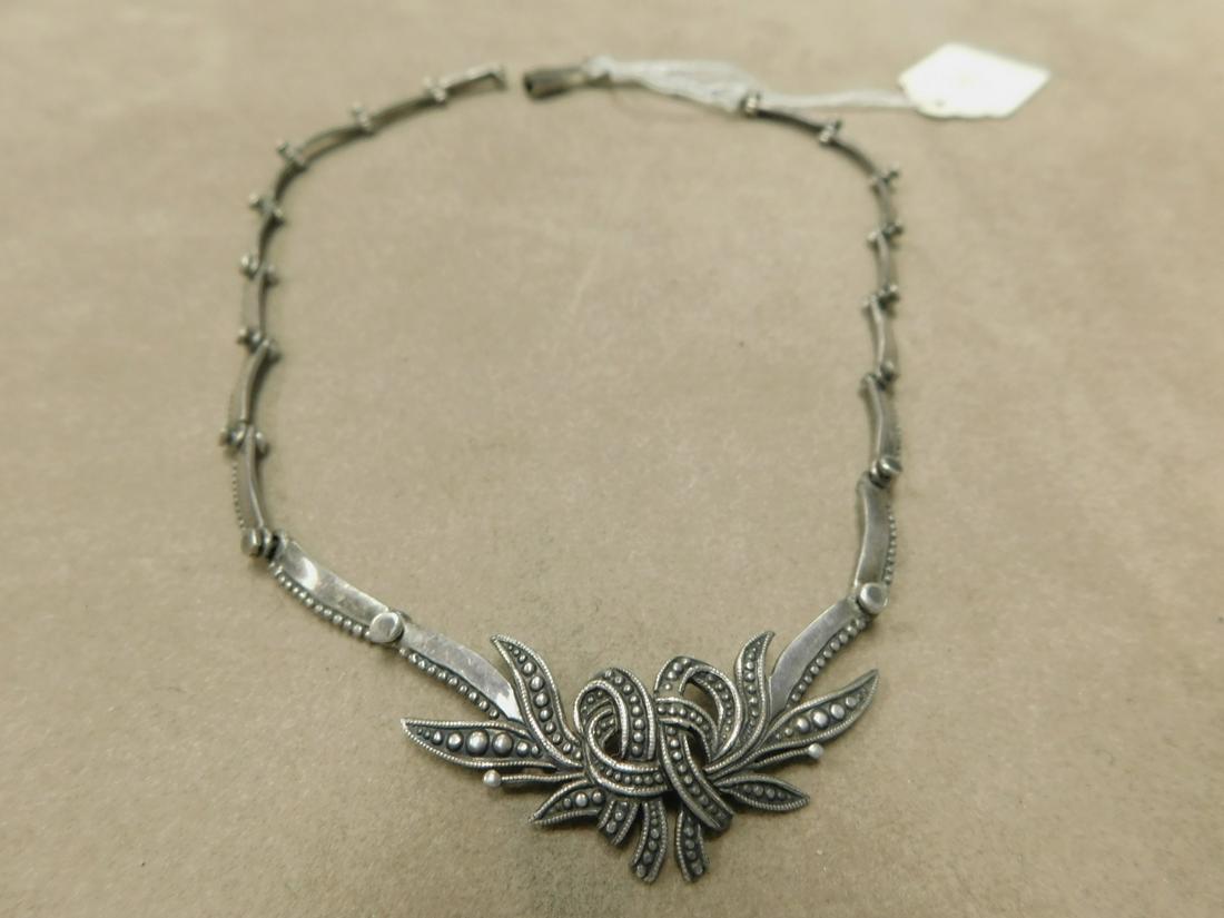 Margot de Taxco Silver Bow Necklace: Margot de Taxco Silver Bow Necklace, 14 1/2" choker, delicate beading, fancy hinged links. Eagle 16 and des number 5346. 77ozt. "V" spring portion of clasp missing. Retails $700.00. CONDITION: Very go