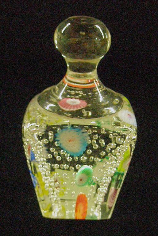 Contemporary Glass Knob Top Paperweight: Contemporary glass 4 1/2" knob top square paperweight with air bubbles & multi colored Millefiori designs. Condition: Very good with minor scratches on base.