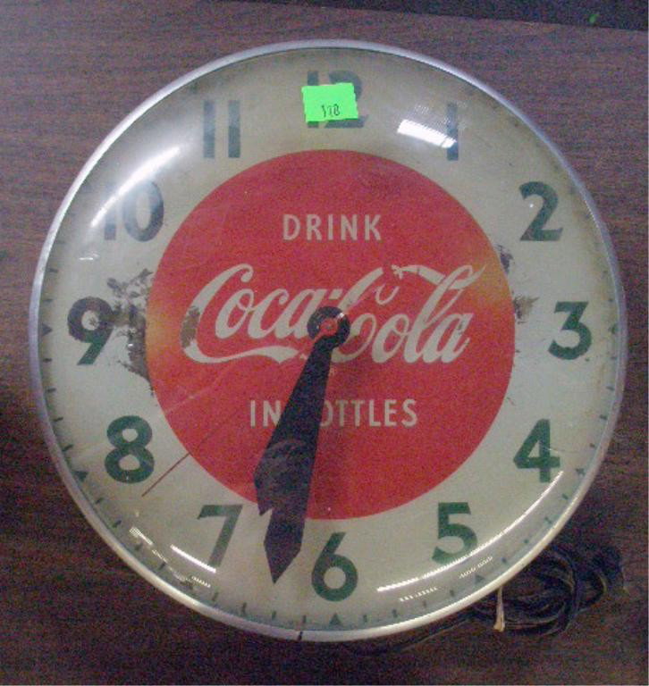 1950's Coca Cola Wall Clock: 1950's Coca Cola glass front 14 1/2" wall clock. Condition: Clock works but does not light up, loss on face, wear & loss on metal casing.
