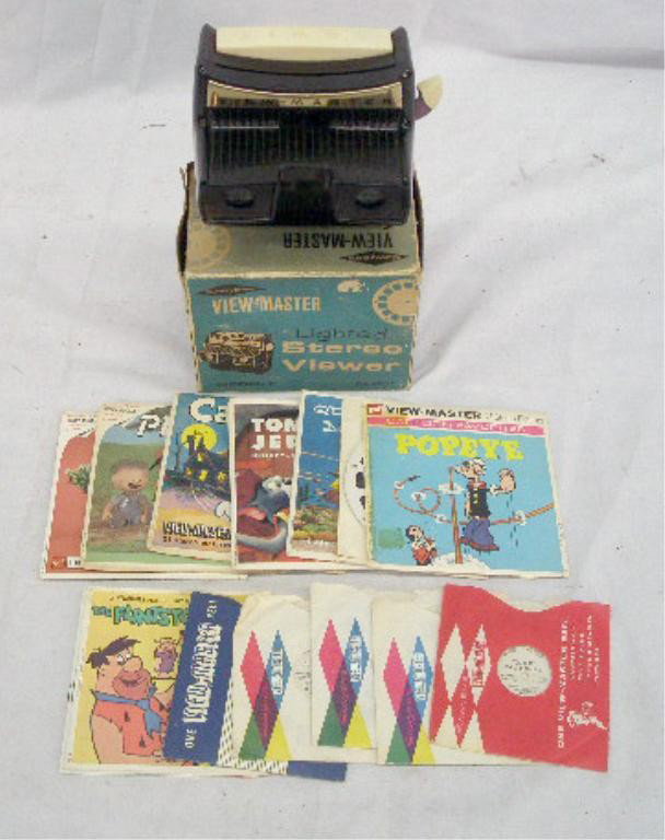 1950's View Master & Reels: 1950's View Master Model F viewer with original box & 28 assorted 1950's & 1960's cartoon character reels. Condition: Viewer does not work, box has wear & loss, reels & holder & have wear.